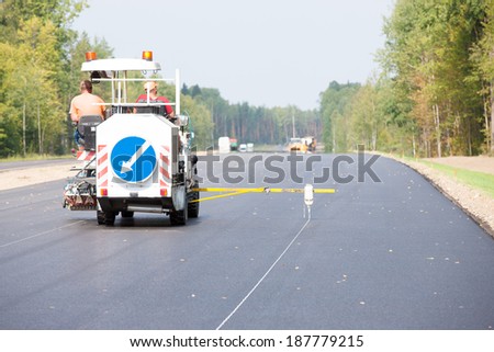 Road surface marking works with thermoplastic spray marking machine