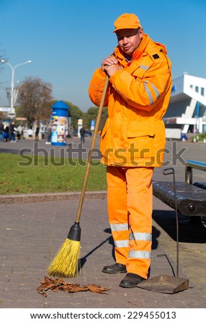 City landscaper janitor with broom tool during street sweeping