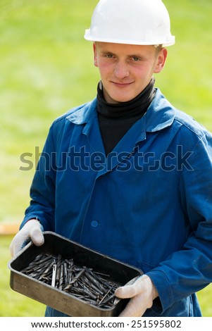 Construction man worker with box with drills tools