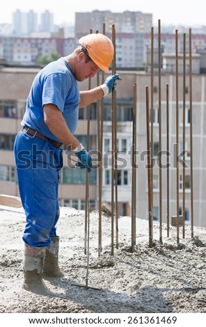 Construction worker compaction ready-mixed concrete with metal tool