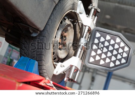 Car at Wheel and Tire Alignment Service with Laser Wheel Alignment System