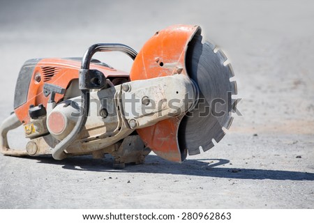 Concrete gasoline saw grinder at construction site