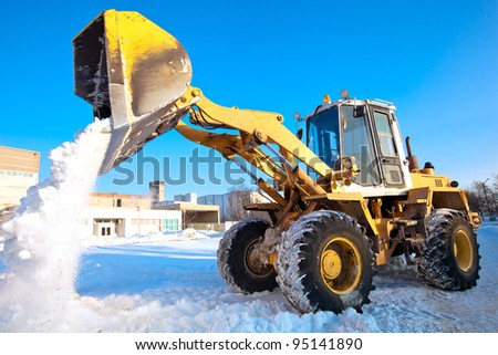 Wheel loader machine unloading snow during municipal works crews