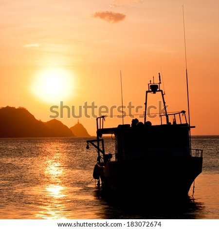 Silhouette of a fishing boat at sunset on the Caribbean coast of Taganga, Colombia