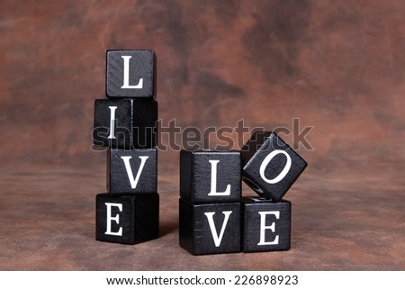 The words \'Live\' and \'Love\' in white letters on black wooden cubes