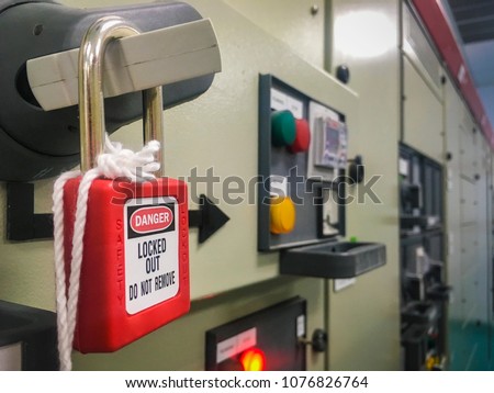 Red lock out tag out key for lock Electrical main power , system protection when repair machine or device in industrial factory