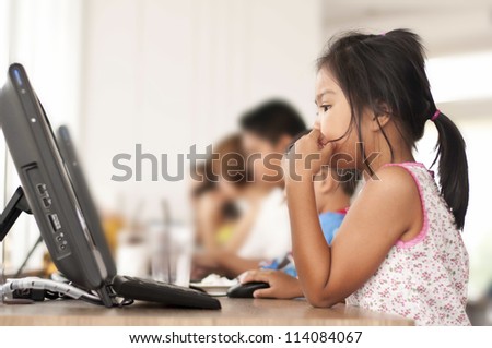Children looking computer in classroom Children looking computer in classroom