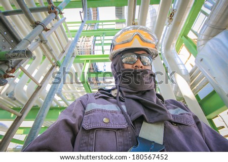 Man with safety personal protection equipment in industrial plant background