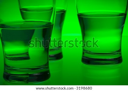 Liquid filled glasses with green backlighting.