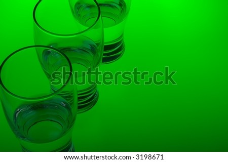 Liquid filled glasses with green backlighting.
