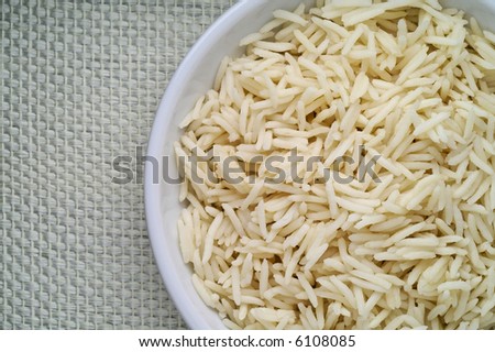 Dish of Basmati rice seen from above over linen tablecloth