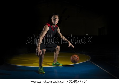 Asian Basketball Player Dribbling Ball