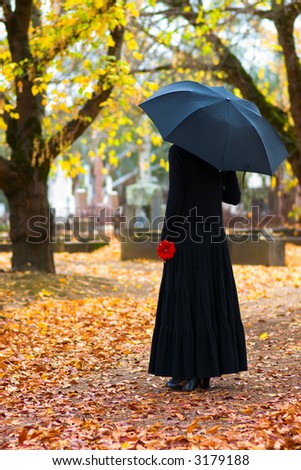 Woman in Mourning at Cemetery in Fall, with Black Umbrella