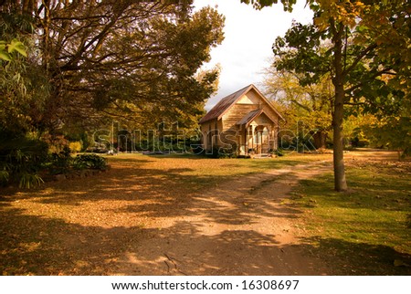 Tiny old chapel in gardens in fall