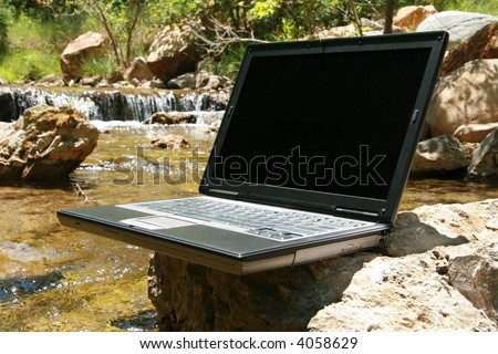 Laptop with river running underneath