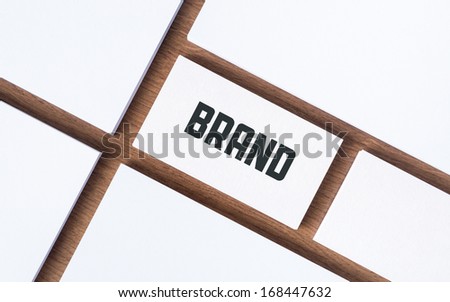 Business Card With Brand Word And With Blank Papers For Company Presentation Or Branding Identity Concept. Above View On A Desk Background.