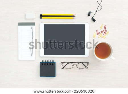 Business workplace with modern blank digital tablet, office supplies and objects for daily routine, regular items on a desk background. Top view.