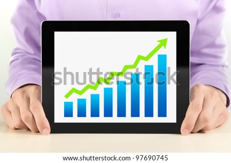 Business man showing tablet pc with success growth graph on screen.