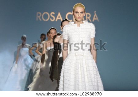 BARCELONA - MAY 08: Models walking with Andrej Pejic model on the front on the Rosa Clara catwalk during the Barcelona Bridal Week runway on May 08, 2012 in Barcelona, Spain.
