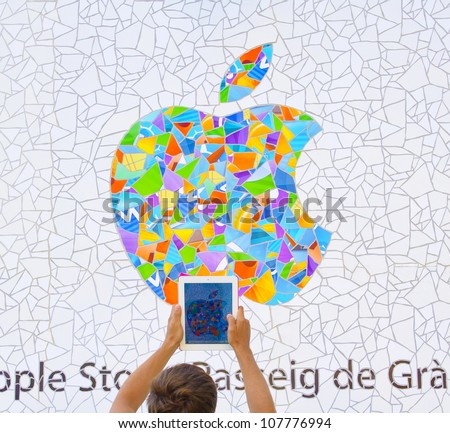 BARCELONA JULY 16 man taking a picture with an ipad of the exterior of the new Barcelona Apple store not yet opened on July 16 2012 in Barcelona Spain BARCELONA JULY 16 man taking a picture with an ipad of the exterior of the new Barcelona Apple store not yet opened on July 16 2012 in Barcelona Spain