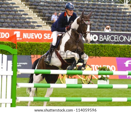BARCELONA- SEPTEMBER 21: Michel Robert in action during the CSIO 101th International jumping competition in Real Club Polo Barcelona, on September 21, 2012, Barcelona, Spain.