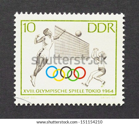 GERMAN DEMOCRATIC REPUBLIC - CIRCA 1964: a postage stamp printed in DDR showing an image of volleyball players in Tokyo 1964 olympics, circa 1964.