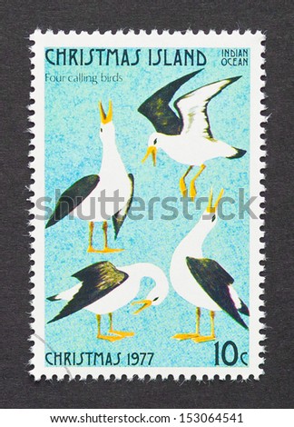 CHRISTMAS ISLAND - CIRCA 1977: a postage stamp printed in Christmas Island showing an image of four calling birds the fourth gift from the Twelve Days of Christmas, circa 1977.
