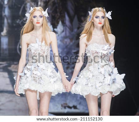 BARCELONA - MAY 07: models walking on the Yolan Cris bridal collection 2015 catwalk during the Barcelona Bridal Week runway on May 07, 2014 in Barcelona, Spain.
