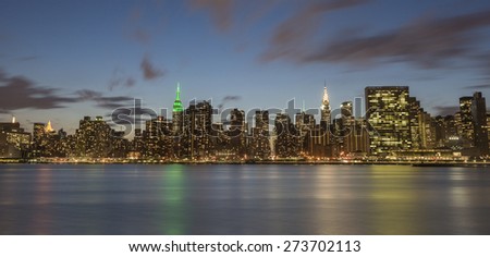 NEW YORK CITY - APRIL 22: New York City Manhattan skyline with Empire State Building, Chrysler Building and United Nations building at night over East River on April 22, 2015 in New York City.