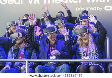 BARCELONA - FEBRUARY 24: people trying the new Samsung Gear VR a glasses mobile virtual reality device on the stand of the Mobile World Congress 2016 on February 24, 2016, Barcelona, Spain.