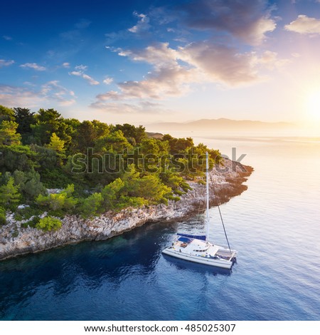 Yacht in amazing bay of pure Greece Sea - Peaceful sunrise at yacht