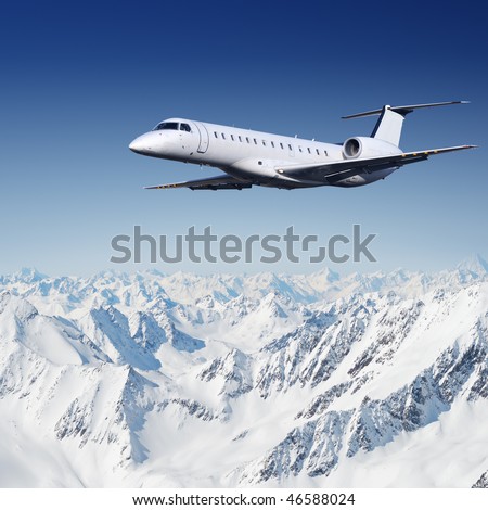 Private jet plane flying over mountains