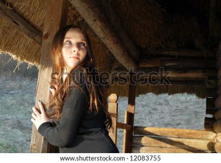 Portrait of a young girl in an ancient house backyard
