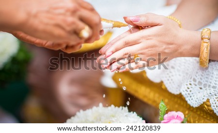 Thai culture, hand of a bride receiving holy water in wedding ceremony