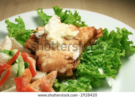 fish fillet with mayo and cream, fresh veggie salad side dish