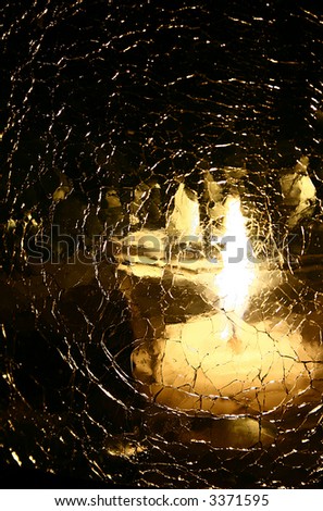 candle light reflection through shattered glass