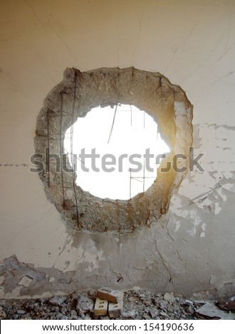 Hole In The Concrete Wall From Tank Shell With Isolated Space