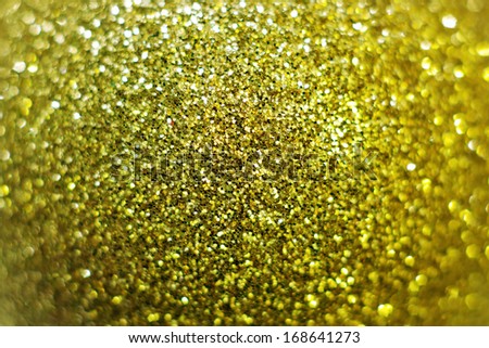 Macro of shiny gold powder pile. Middle focus with bokeh.