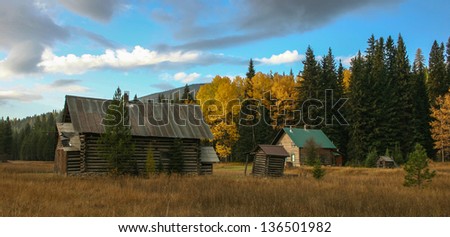 A panorama of a remote farm in mountain and fall settings
