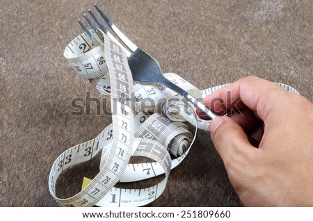 Measurement tape knotted with fork