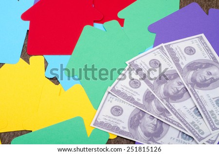 Money over the colorful house paper cut-out