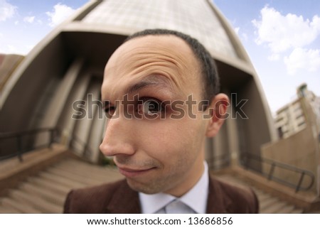 close up with a fish eye of a man\'s face with the eyebrow raised