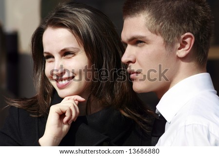 woman smiling and man profile looking far away outdoors