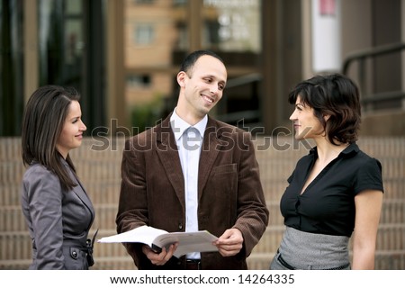 business team talking at staff meeting outdoors