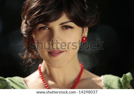 Young attractive woman looking at the camera and softly biting her the lower lip in a hot summer day