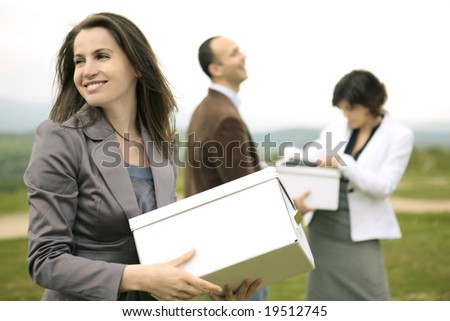 happy smiling business team outdoors organizing files and boxes on a hill