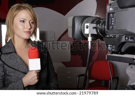 serious TV reporter in live transmission  looking at the video camera