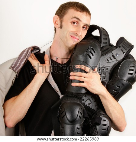 Biker holding close to his face a sport protective suit as his style choice and a business suit on the other hand