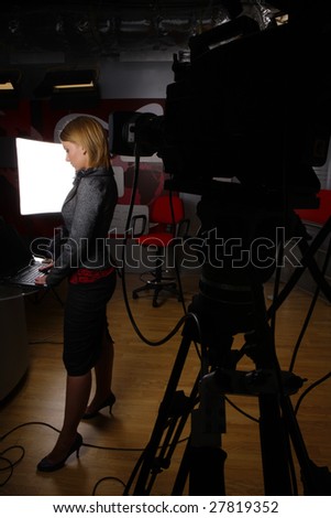 full length news reporter in television studio before transmission