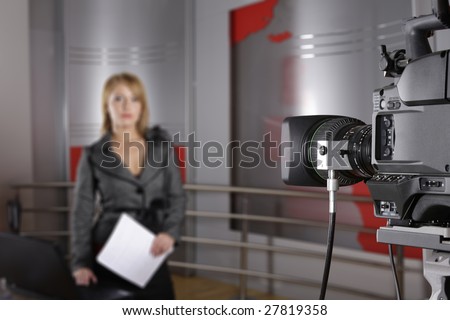 unrecognizable television news reporter in front of the video camera in studio in live transmission